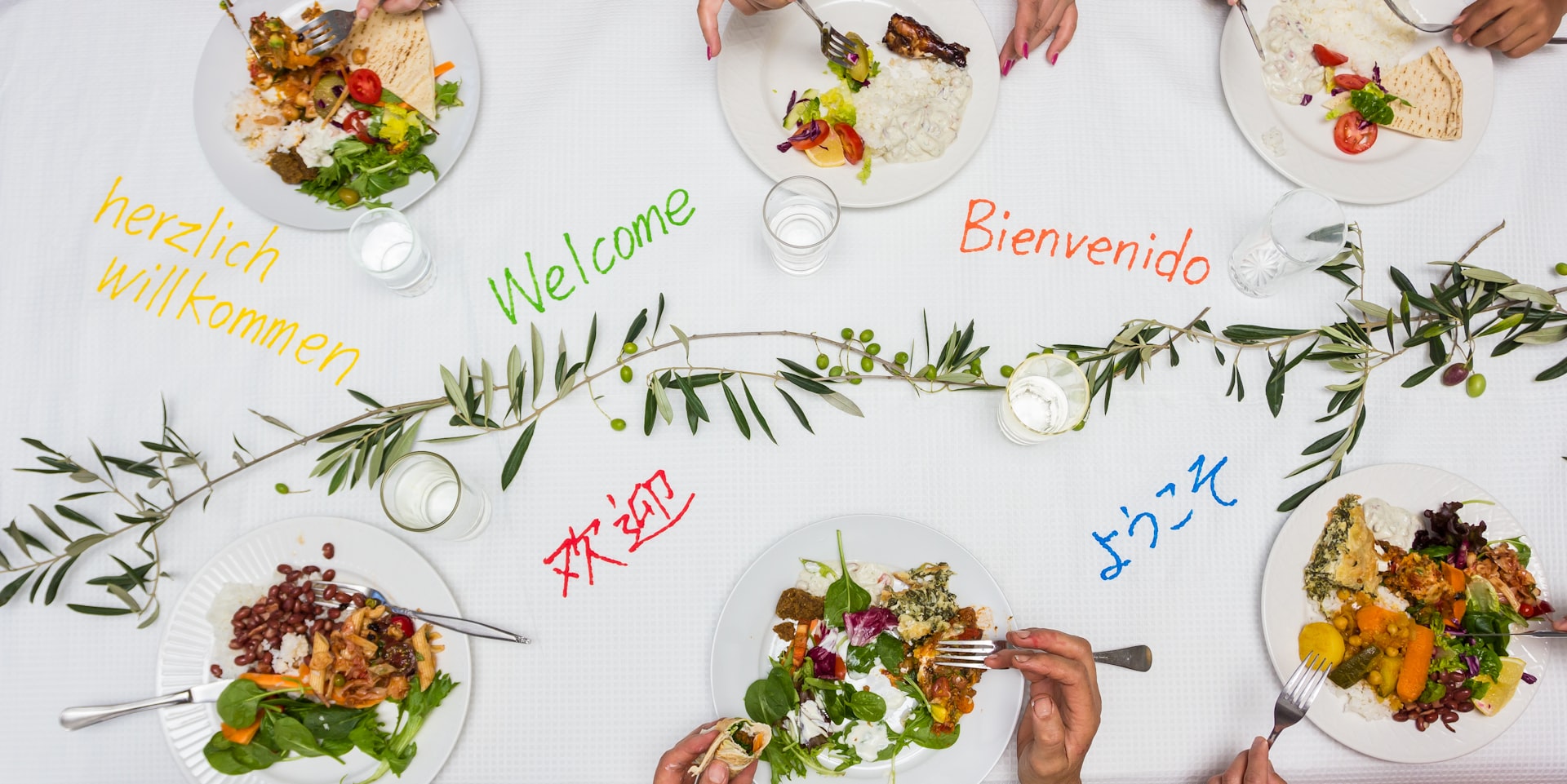 A group of people sitting at a table with plates of food